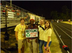 People pose with a Recycling Bottles and Cans sign