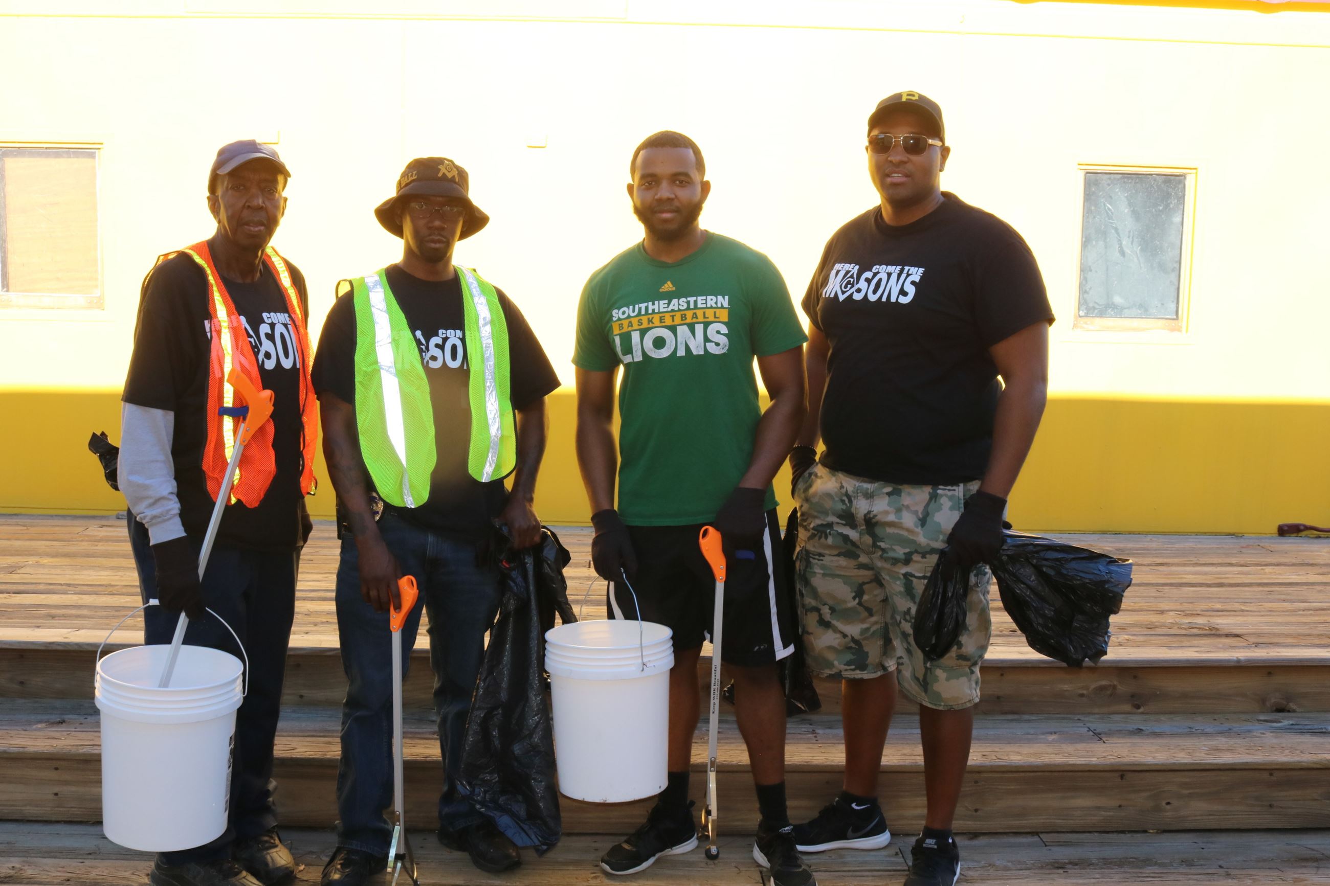 Four men pose together during the clean up event