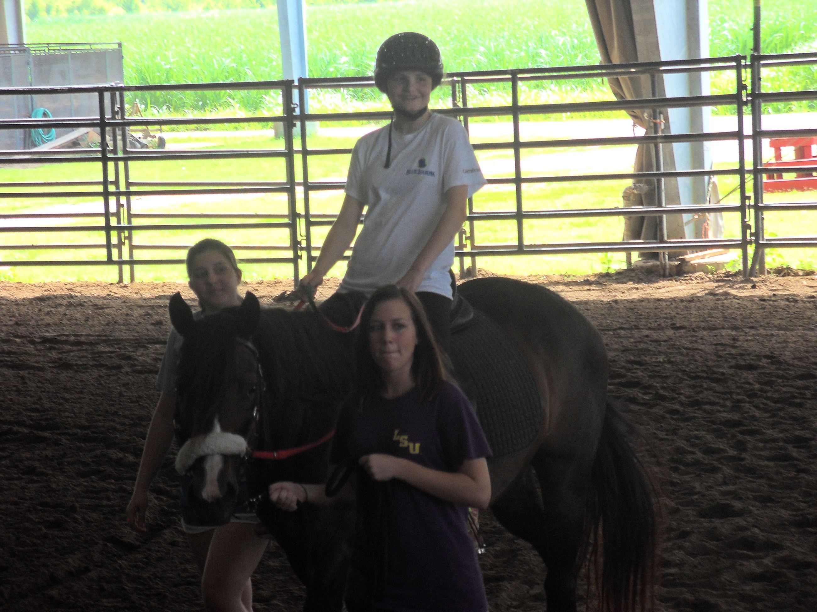 Boy riding a horse around the arena